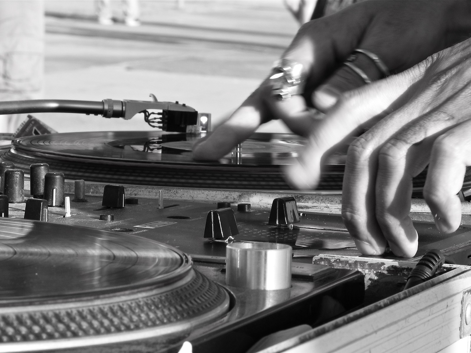 A pair of hands operating two turntables.