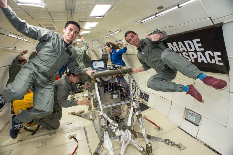 A group of people "floating" while on board a parabolic flight that simulates zero gravity.