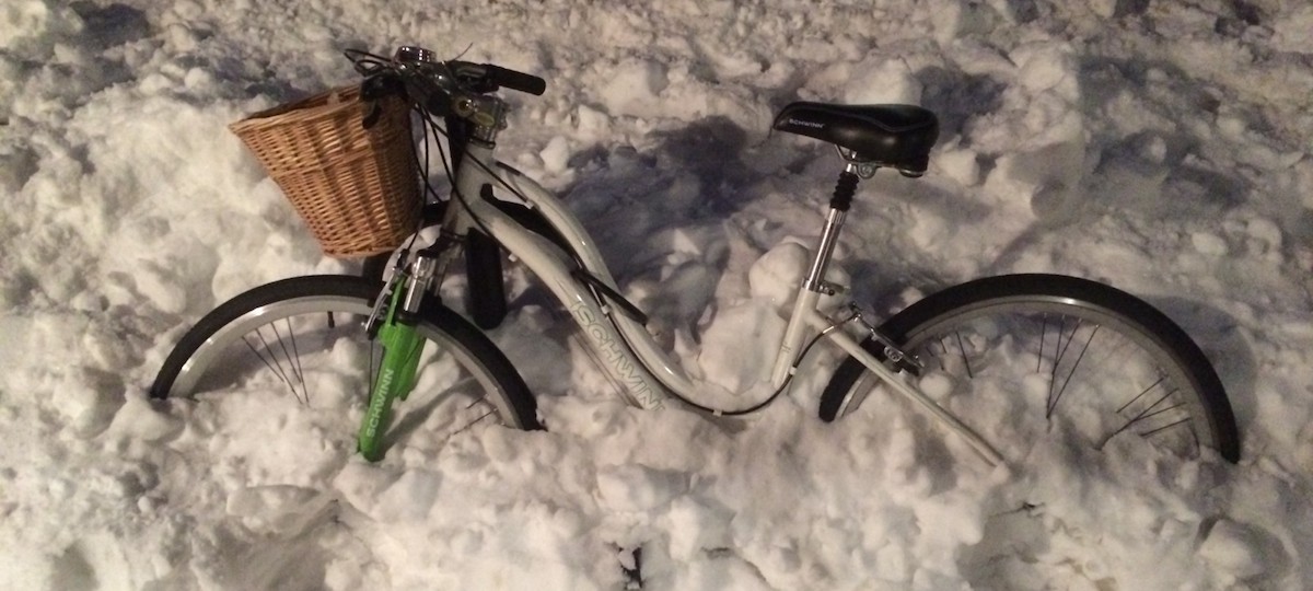 A bike buried in snow.