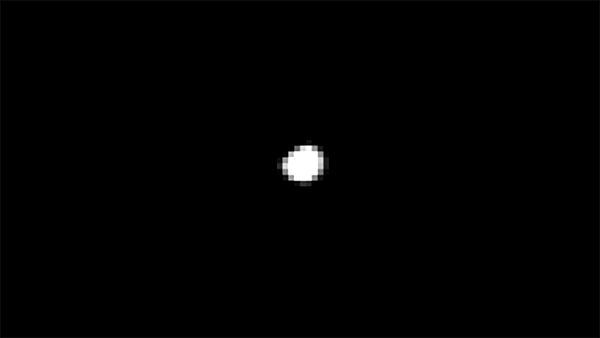 The first moving object looks like a small shifting mass of white pixels on a black background. It transitions into the clear image of the comet, shaped like a rubber duck, spinning through space.