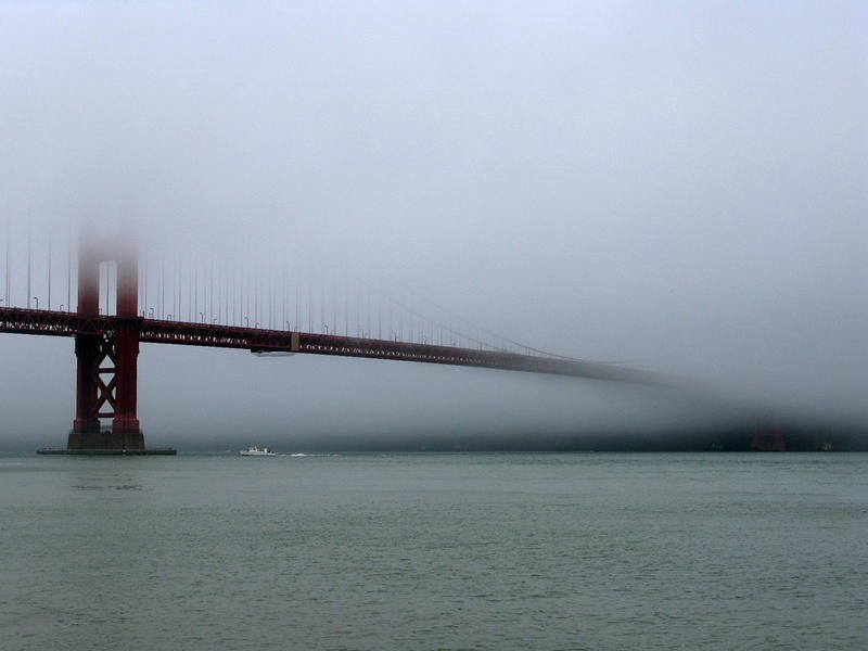 The Golden Gate Bridge, semi-obscured by fog on the Bay.
