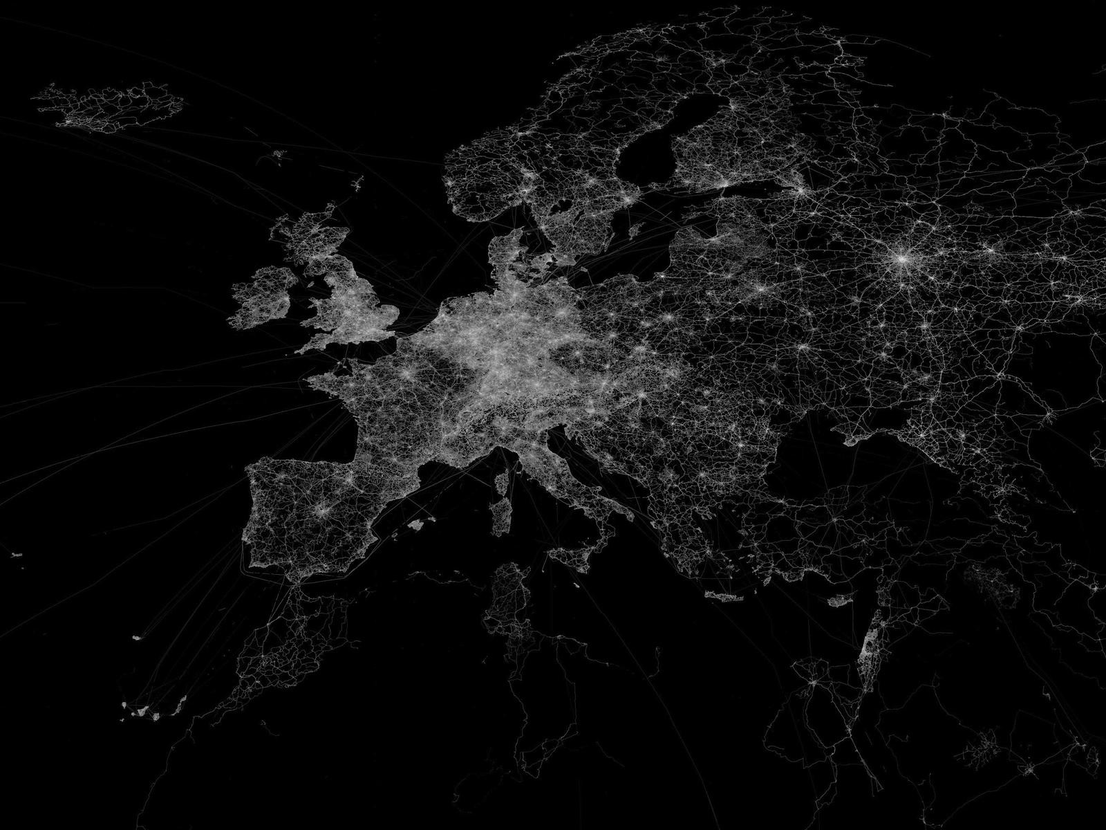 A satellite view of Europe at night, showing cities and towns lit up by lights.