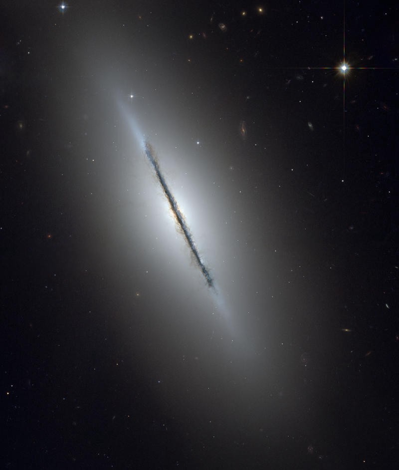 An extremely thin, long galaxy disk against an empty dark background with few other stars.