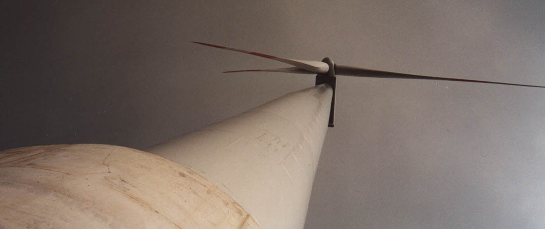 A wind turbine, viewed from below.