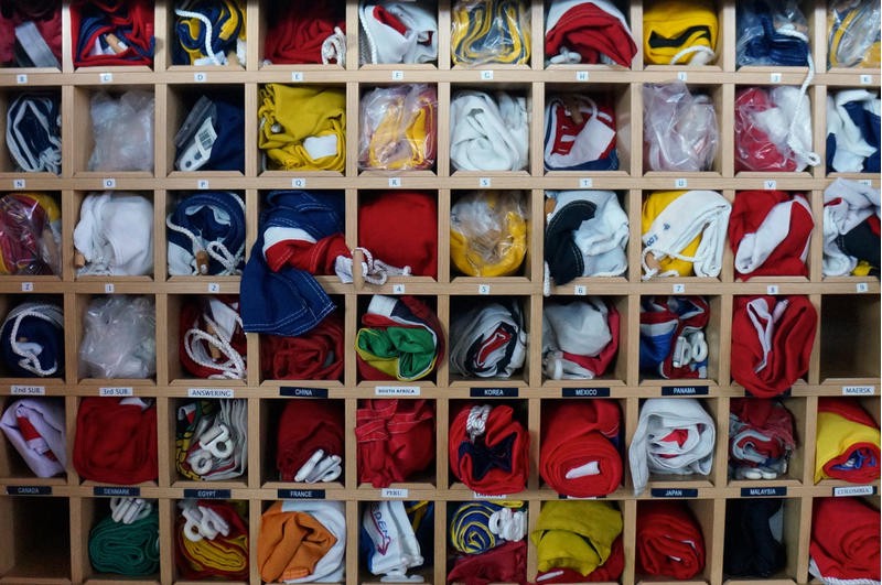 A wall of box shelves, each unite containing a crew member's personal clothing.