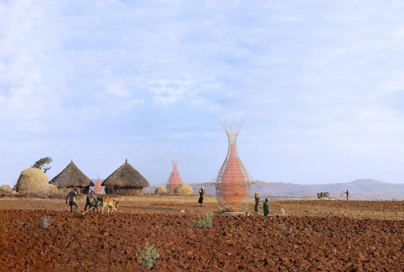 A CGI render of a rural Ethiopian village of huts, with 10 foot-tall towers dotted around collecting water.