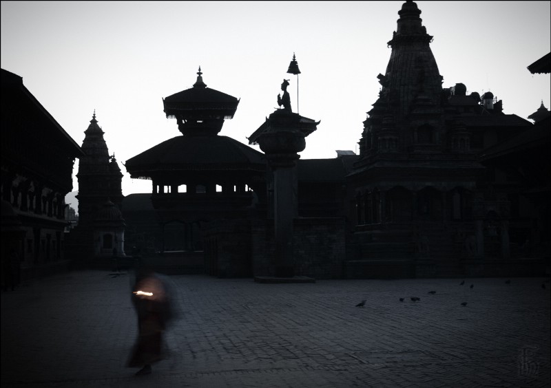 A courtyard outside a Nepalese temple at dusk.