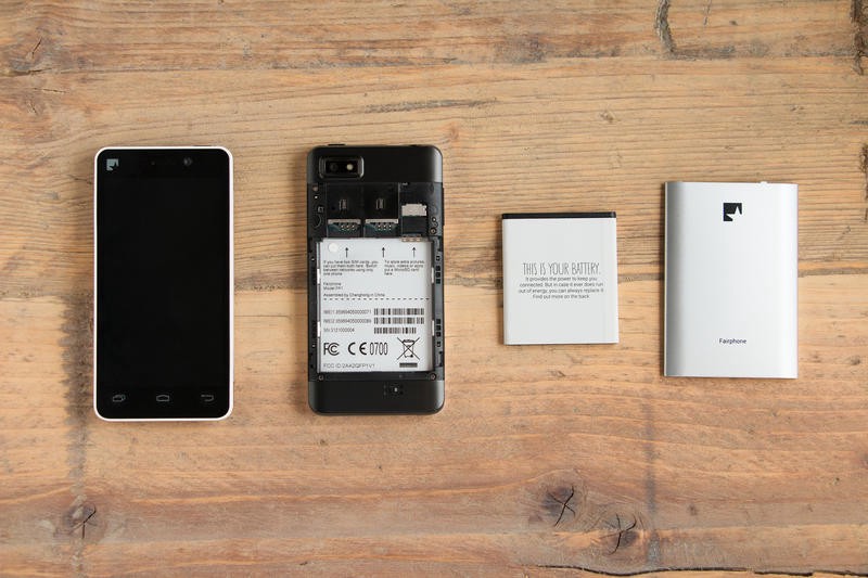 The FairPhone disassembled into screen, body, battery, and battery cover.