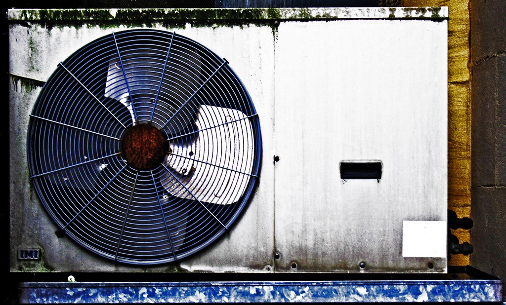 A commercial air conditioner unit on the side of a building.