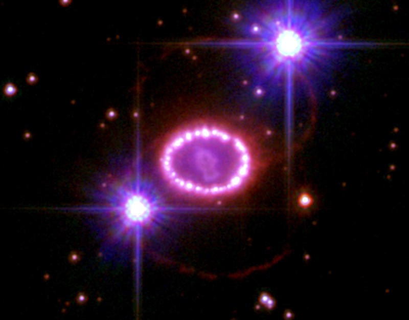 Bright purple stars, one with a circle of gas around it.