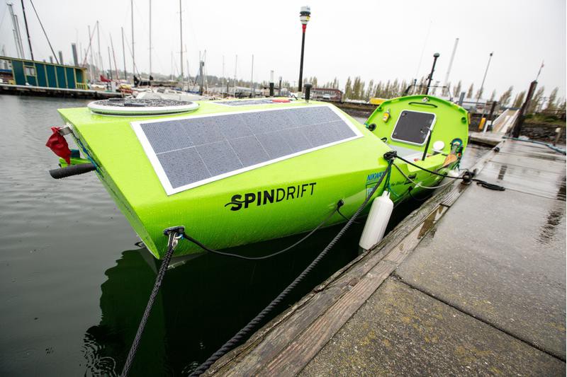 Spindrift, Sonya Baumstein's bright green boat, moored up at a dock.