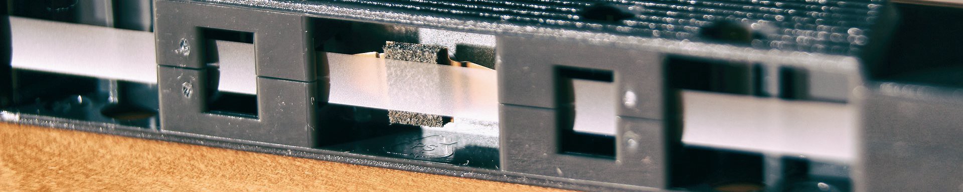 A close-up of the read/write head on a cassette tape.