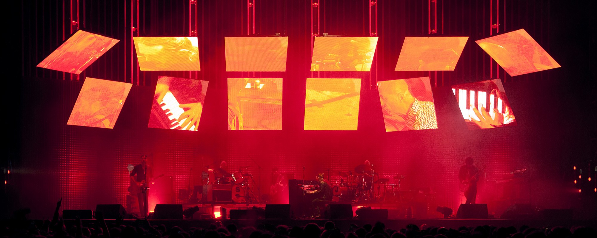 The band Radiohead performs on a stage at a gig.