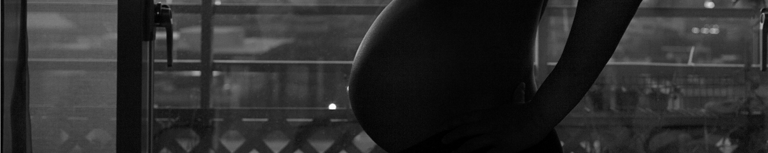 A pregnant figure in silhouette.