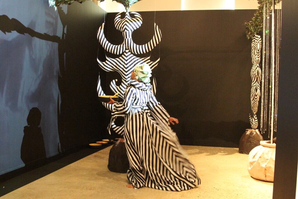A person wearing a striped haute coutoure gown.