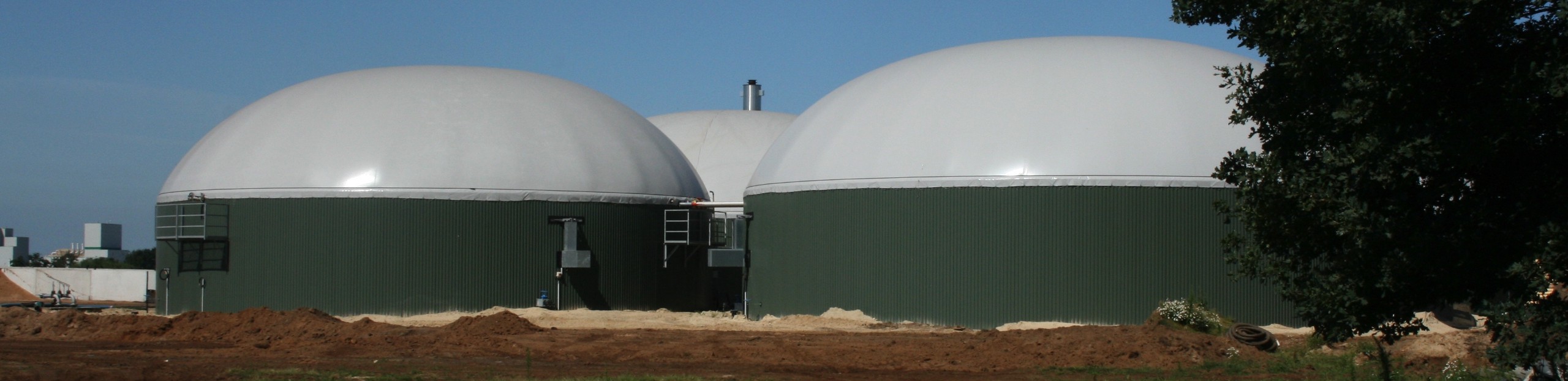 Large circular tanks with dome roofs.