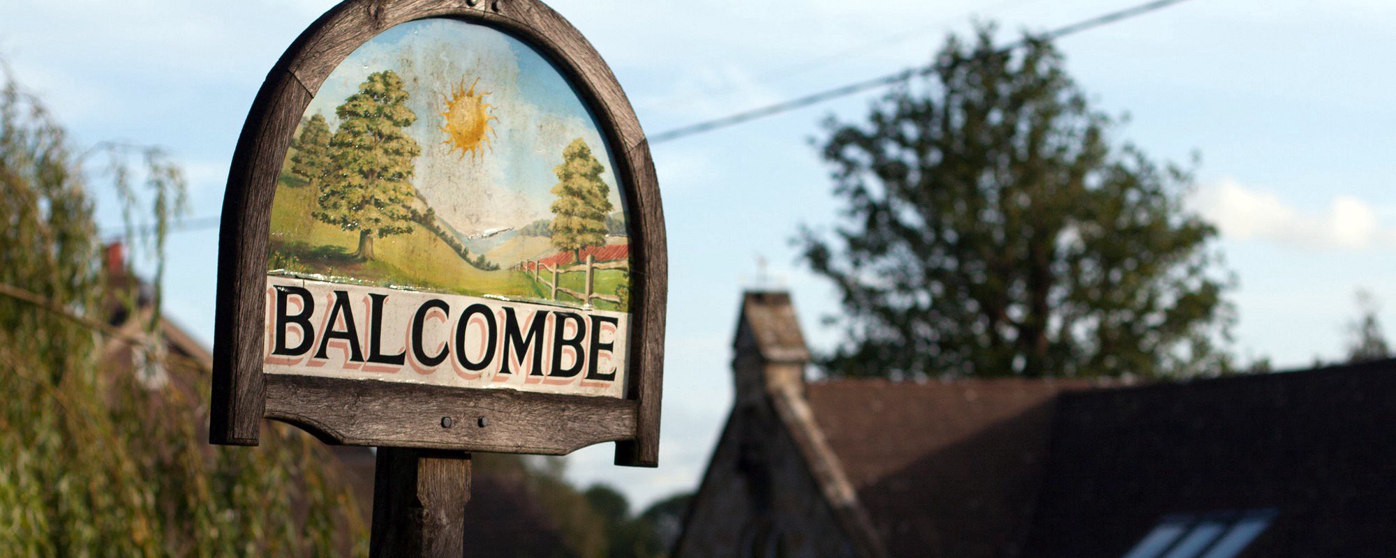 Balcombe's village sign, with the primary school in the background.