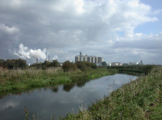 A view of large storage tanks at a facility in the distance.