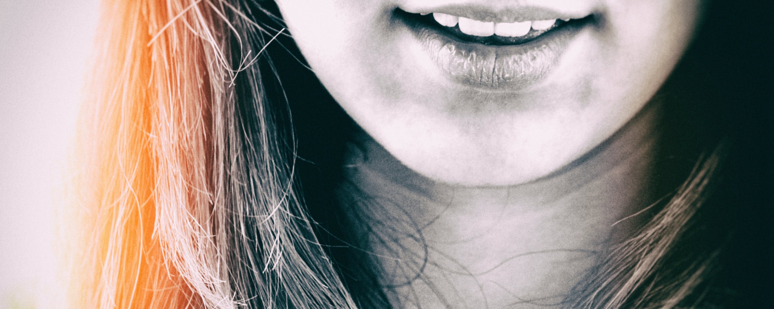 A woman's mouth, smiling.