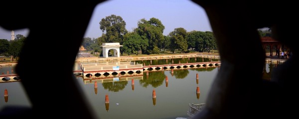 A large artificial ornamental lake with prestigious structures around the outside.