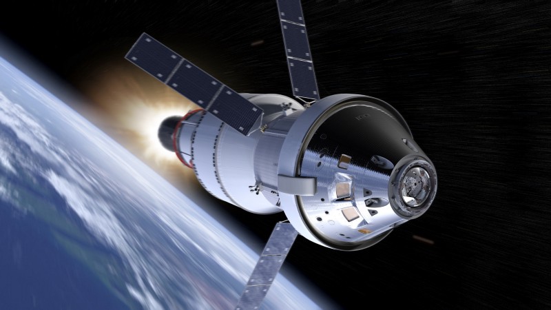 A spacecraft with solar panels arranged like wings blasts through space, above the Earth.
