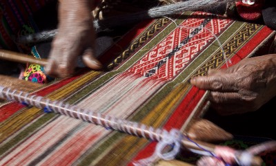Hands weaving fabric.
