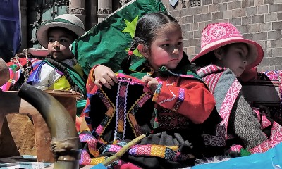 Children practice weaving fabric.