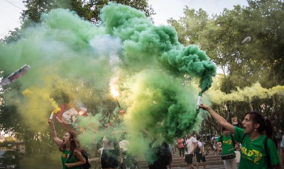 Protesters let off green smoke grenades.