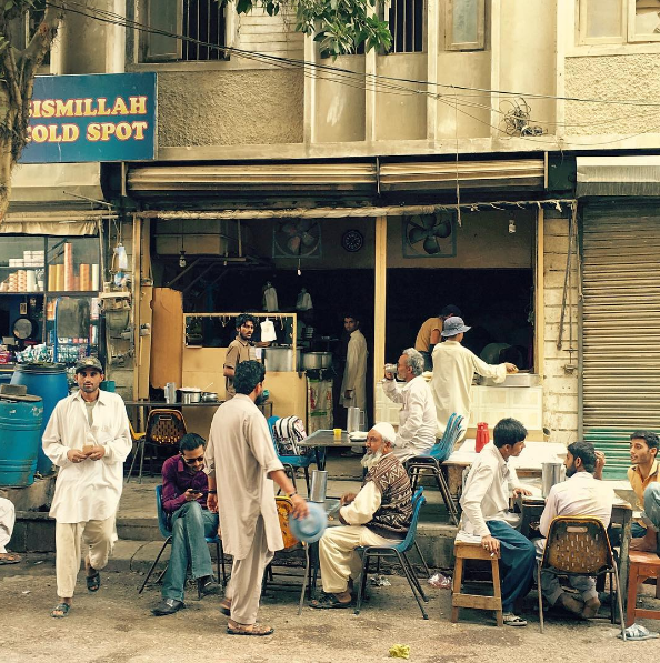Men sitting outside a coffee shop in Karachi