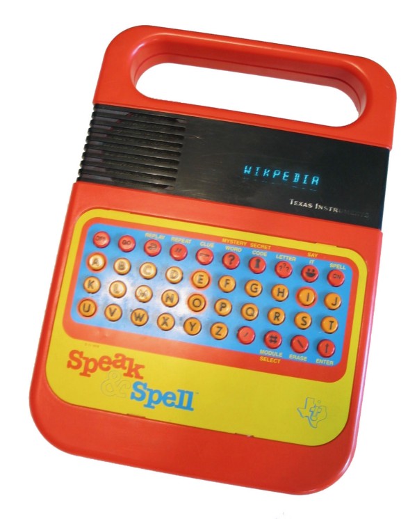 A red plastic Speak and Spell unit, with a keyboard and basic LED screen showing words.