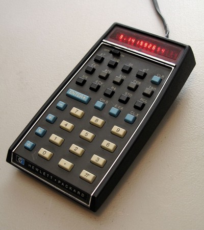 A black calculator with power cable.