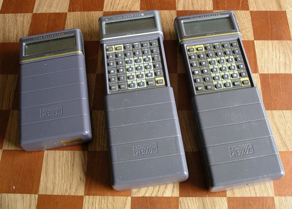 A large grey handheld computing device with a folding-down cover.