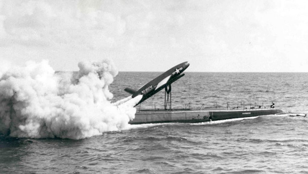 A rocket is fired from the top of a submarine that has surfaced.