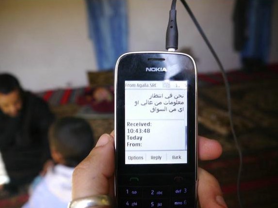 A phone displaying Arabic text.